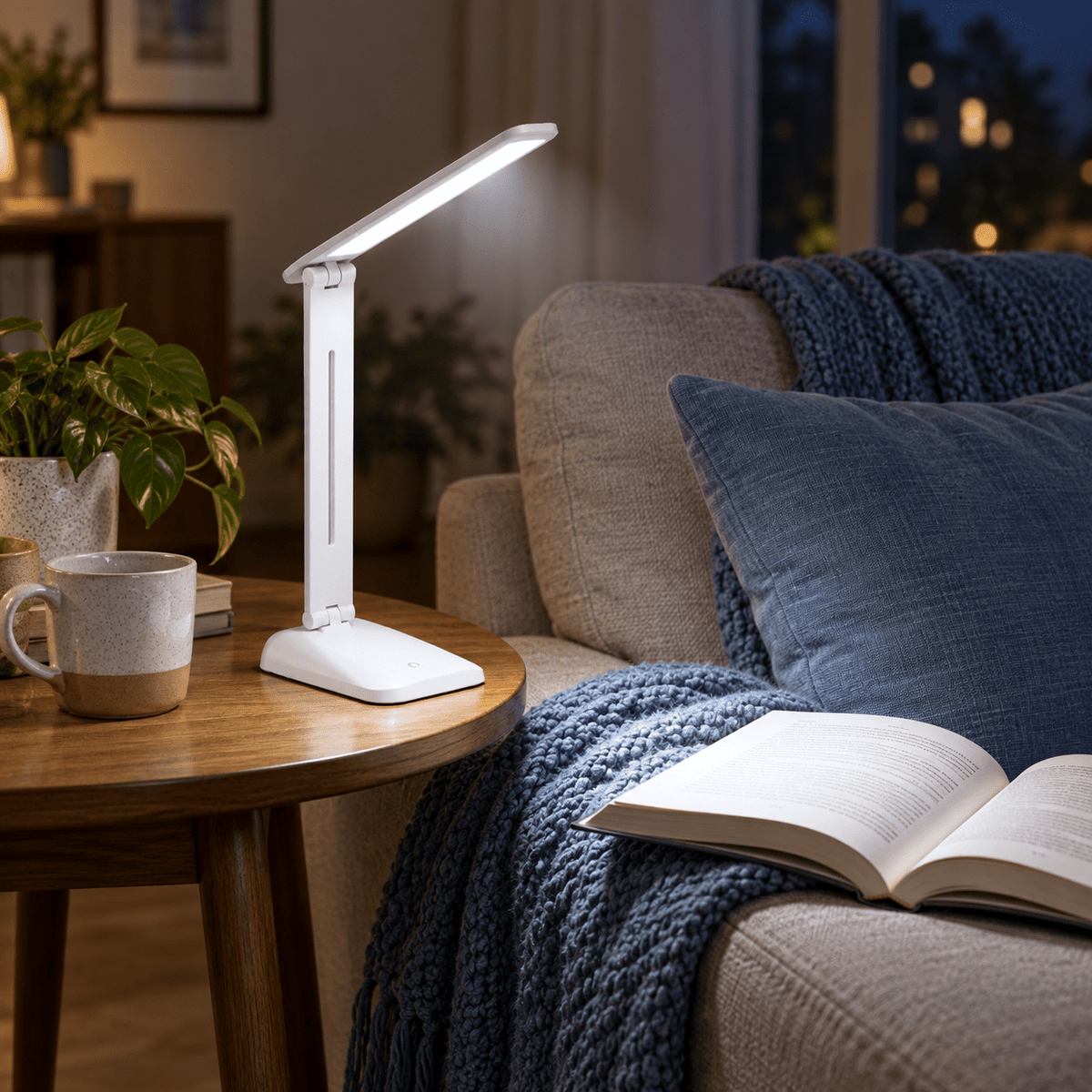 Sophia Rechargeable LED Table Lamp lifestyle scene: Living room side table, aiming light toward a couch reading chair