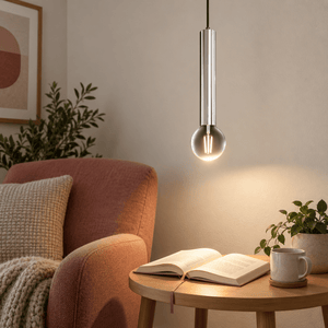 Grace Satin Chrome Pendant Light lifestyle scene: Close detail of satin chrome pendant over a quiet reading corner