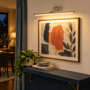 Asha Satin Picture Light 8W LED - Warm White lifestyle scene: Dining area wall beside a small console, warm highlight for framed menu art