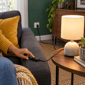 2 Core Cable with Switch & Plug - 1.8m Black Power Cord lifestyle scene: Lounge wall socket behind sofa arm
