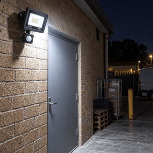 20W LED Black Flood Light IP65 - PIR Sensor — shop loading entrance at night