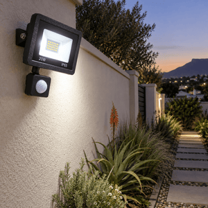 20W LED Black Flood Light IP65 - PIR Sensor — garden boundary path at twilight