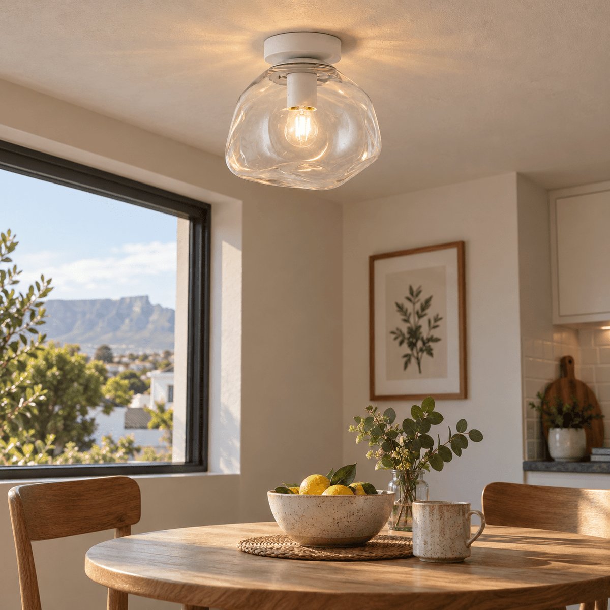 Small Glass Molten Ceiling Light – Clear Glass and White — above a compact breakfast table