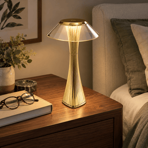 Golden Pixie Gold LED Table Lamp - Rechargeable Portable — on a bedside table
