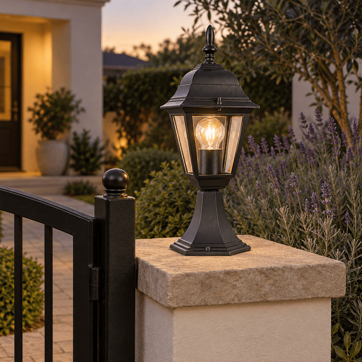 Black Outdoor Pillar Light IP33 — mounted on a garden gate pillar at dusk