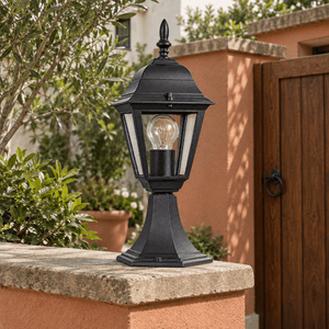 Black Outdoor Pillar Light IP33 — on a courtyard wall in natural daylight