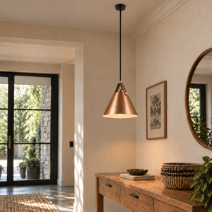 Large copper leather and iron pendant light with long black suspension, switched on — over an entry console
