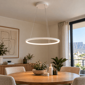 White 60cm continuous LED ring pendant illuminated above a dining table, with three fine suspension wires.