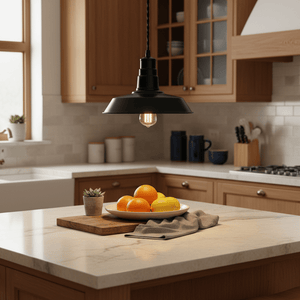 Black LED pendant light hanging over a kitchen island with a bowl of oranges and a potted plant.