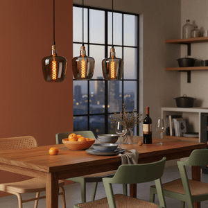 Dining room with wooden table, chairs, and pendant lights.