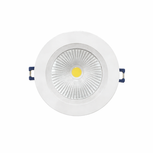 White recessed ceiling light with a yellow center on a white background