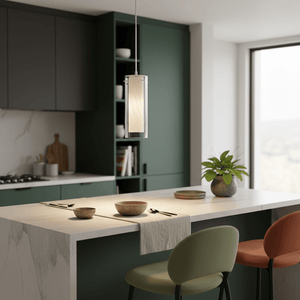 Double glass pendant light hanging over a modern kitchen island with bowls and cutlery on the countertop.