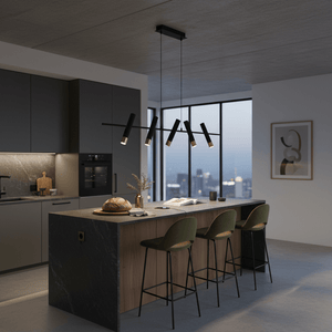 Modern 5 light LED pendant in black and gold above a kitchen island with a loaf of bread and decorative items.