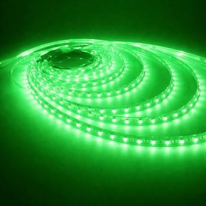 Green LED strip light coiled on a dark background