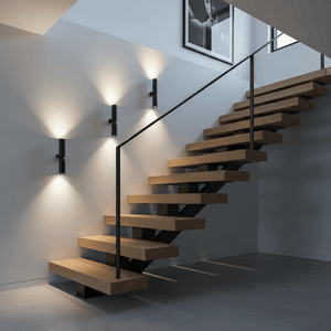 Stylish black up and down wall lights illuminating a modern staircase, enhancing the space's ambiance.