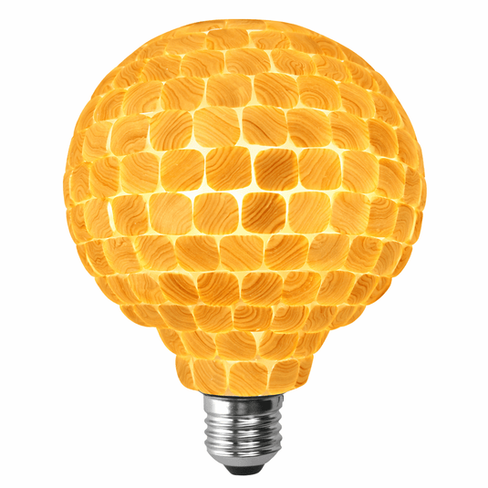 Close-up of a decorative LED filament bulb with a mosaic design, showcasing its warm glow and unique texture.