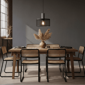 Stylish dining setup featuring a mesh and stone pendant light above a wooden table with decorative elements.