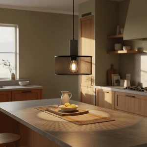 Industrial-style pendant light with mesh shade illuminating a kitchen island with a bowl of lemons.