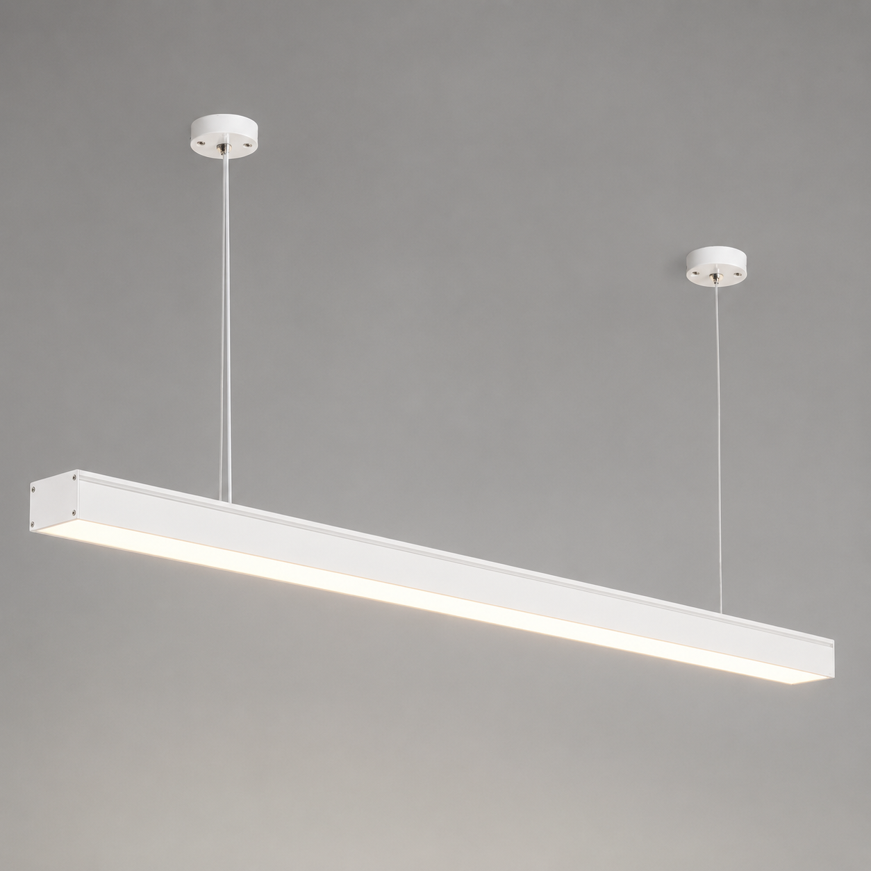 Sleek matt white linear LED pendant light suspended from the ceiling against a grey background.