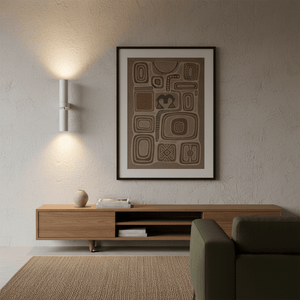 Banyan White Up & Down Wall Light illuminating a textured wall art above a wooden console table.