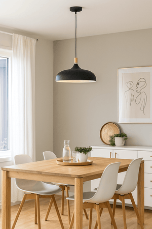 Dining room with wooden table, chairs, and a black pendant light.