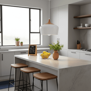 Scandinavian-style pendant light hanging over a kitchen island with lemons and plants.