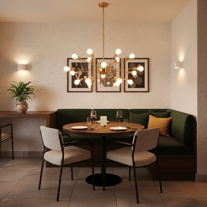 Satin gold pendant light hanging above a round dining table with green seating and decorative elements.
