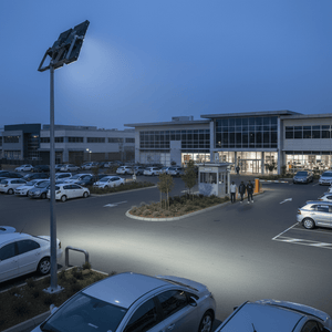 960W modular LED floodlight illuminating a parking area at dusk, enhancing visibility for pedestrians and vehicles.