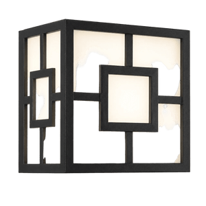 Black square outdoor bulkhead light with geometric cut‑out panels, illuminated against a black background.