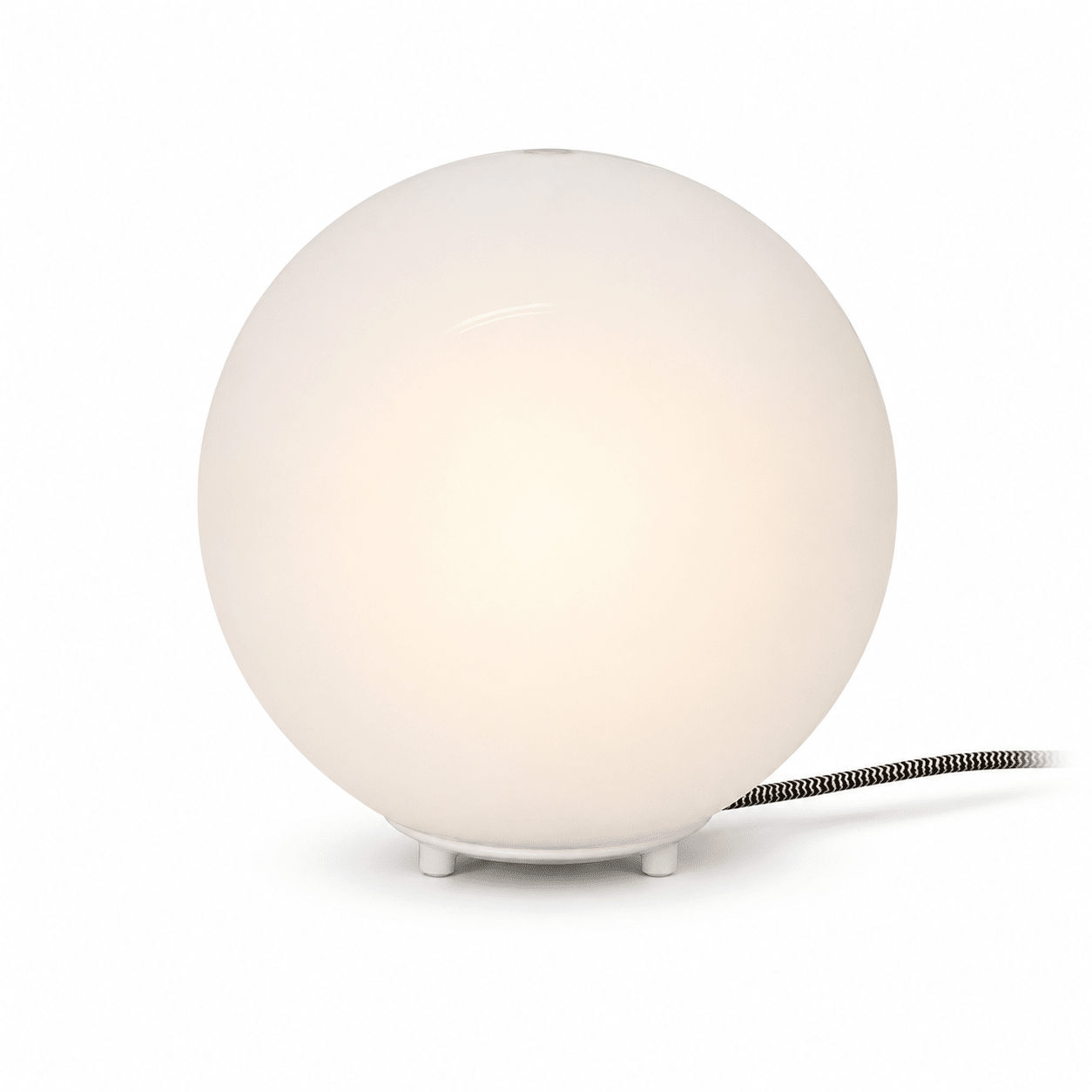 Close-up of the Global Table Lamp featuring a round opal shade and a sleek base, showcasing its minimalist design.