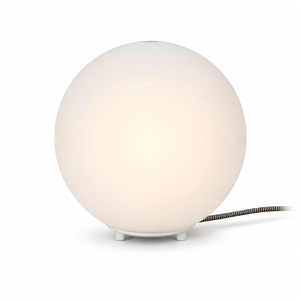 Close-up of the Global Table Lamp featuring a round opal shade and a sleek base, showcasing its minimalist design.