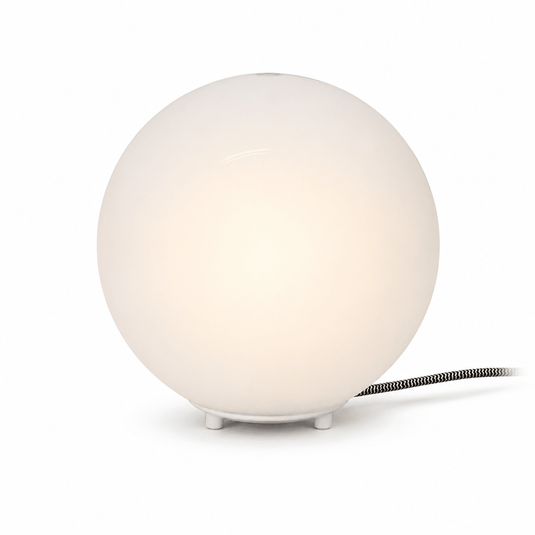 Close-up of the Global Table Lamp featuring a round opal shade and a sleek base, showcasing its minimalist design.