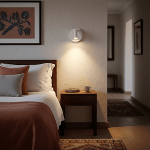 Rechargeable LED bedside wall light mounted beside a bed, illuminating a cozy bedroom scene.