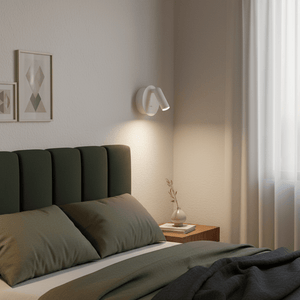 Rechargeable LED bedside wall light mounted beside a green upholstered headboard in a cozy bedroom setting.