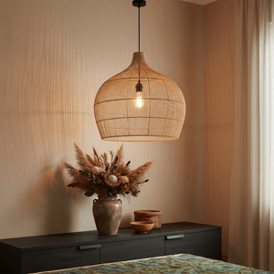 Haiti Bamboo Rattan Pendant light hanging above a dark wooden console with decorative vase and plants.