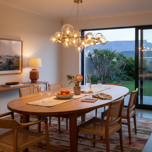 Stylish round pendant light with cognac glass bubbles hanging over a wooden dining table in a modern setting.