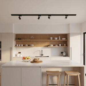 Black 3-wire track with four adjustable spotlights mounted above a modern kitchen island