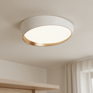 Close-up view of a white and copper flush ceiling light installed on a ceiling, showcasing its sleek design.