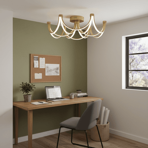 Matt gold LED ceiling fitting illuminating a modern office space with a desk and laptop.