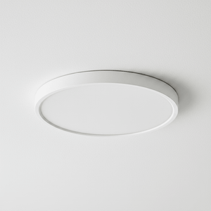 Close-up view of a slim round white LED ceiling light mounted flush to a textured ceiling.