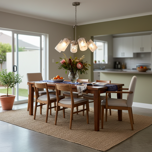 Dining room with a satin chrome chandelier and frosted glass shades above a wooden table.