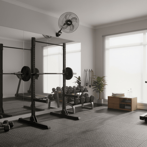 Wall-mounted industrial fan installed in a home gym, providing airflow above workout equipment and weights.