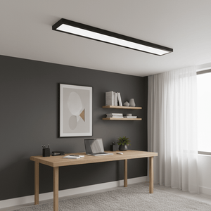 Black surface mount linear LED panel light installed above a modern wooden desk in a stylish office setting.