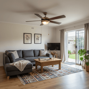 Antique brass ceiling fan with five blades in a cozy living room setting, enhancing the decor.