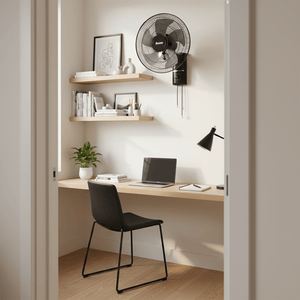 Stylish black wall-mounted fan in a modern home office setting with a desk and shelves.