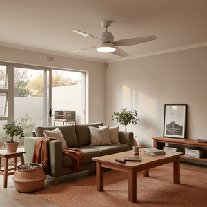 Modern living room featuring a white steel and glass ceiling fan above a green sofa with decorative pillows.