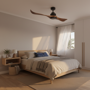 Sleek ceiling fan with wood-finish blades above a cozy bed in a modern bedroom setting.
