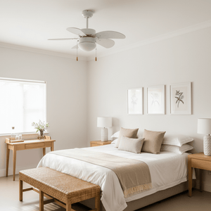 Modern white ceiling fan with six blades installed in a serene bedroom setting.