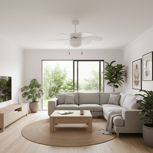 Modern white ceiling fan installed in a bright living room with a sectional sofa and plants.