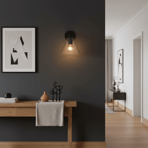 Black Trend wall light illuminating a stylish café interior with wooden table and modern decor.